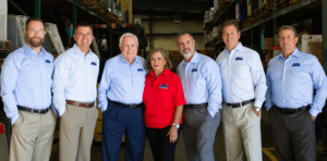 Industrial Battery and Charger Products Page Warehouse shot with Leadership team
